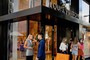 Shoppers exit the Louis Vuitton store in Miami, Florida