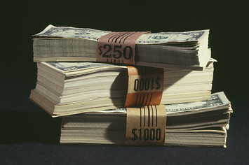Photograph of stacks of cash in USD