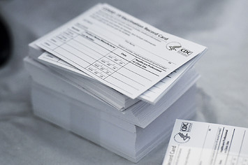 Photograph of stack of blank vaccine cards