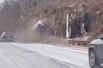 A car is seen crashing on a highway