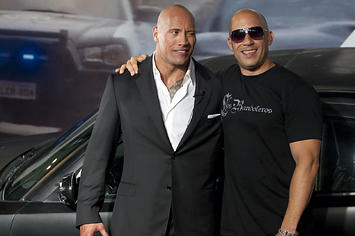 Dwayne Johnson (The Rock) and Vin Diesel (R) pose for photographers.