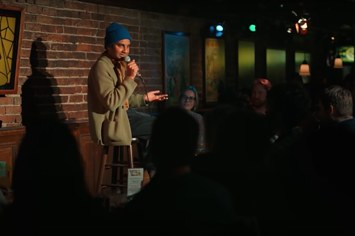 Aziz Ansari is pictured performing comedy