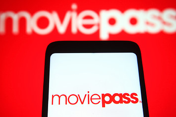 moviepass logo on a cell phone with other logo in back