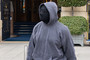 The artist formerly known as Kanye is seen in a mask and hoodie