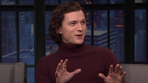 Tom Holland stopped by 'Late Night With Seth Meyers' Monday, where he revealed that one of his 'Spider-Man' co-stars wore butt padding in their suit.