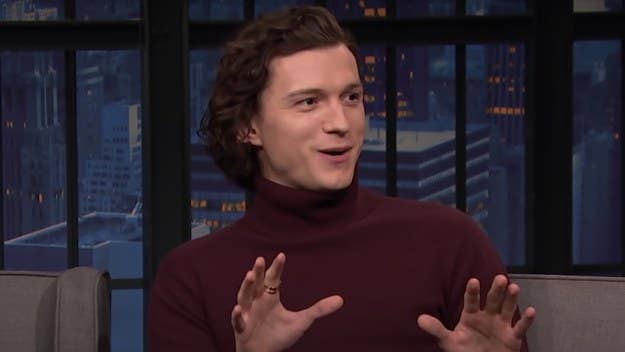 Tom Holland stopped by 'Late Night With Seth Meyers' Monday, where he revealed that one of his 'Spider-Man' co-stars wore butt padding in their suit.