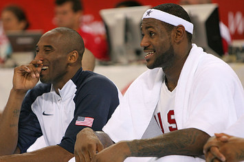 Kobe Bryant #10 and Lebron James #6 of the United States share a laugh on the bench.