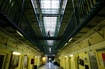 Photograph of a person walking in a prison