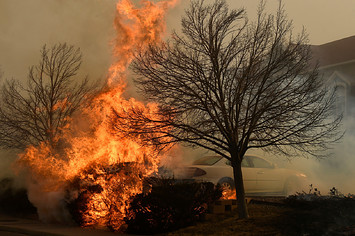 Fire burns in bushes near a La Quinta hotel on December 30, 2021 in Louisville, Colorado
