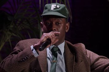 Tyler, the Creator is pictured speaking into a microphone