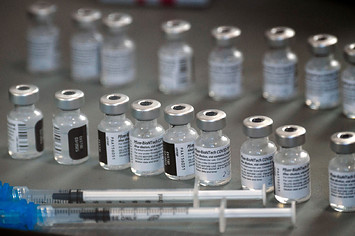 Photo of syringes and vials of the Pfizer vaccine.