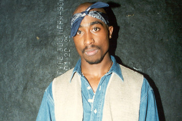 2Pac poses backstage after a show
