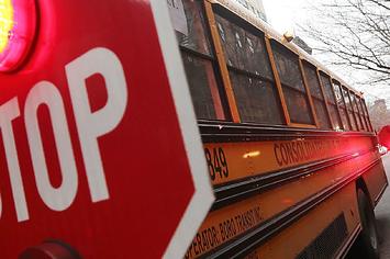A school bus is stopped while picking up a student in Manhattan