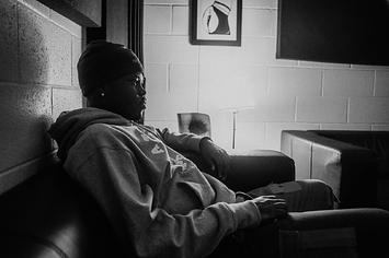 Montreal rapper Skiifall sitting backstage