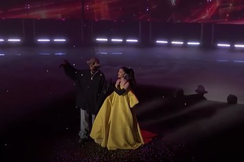Kid Cudi and Ariana Grande stand on a stage