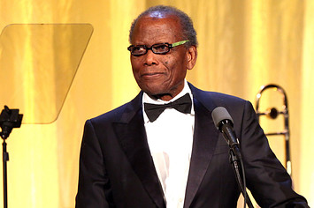 Sidney Poitier onstage in glasses