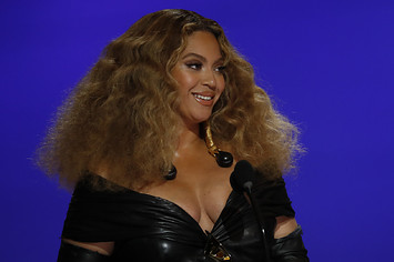 Beyonce is pictured on a stage addressing a crowd