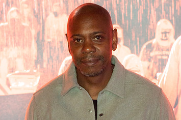 Dave Chappelle is seen posing for a photo.