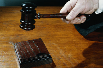 Close up of judge holding gavel.