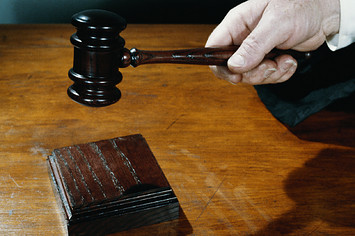Close-up of judge holding gavel.
