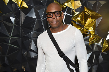 Comedian Dave Chappelle attends a Netflix event and poses for a photo.