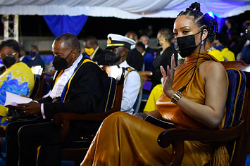 Rihanna waves at the crowd during a special ceremony.
