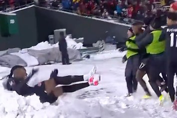 Sam Adekugbe jumps into snowbank in Edmonton following Canadas win against Mexico for World Cup qualifiers.