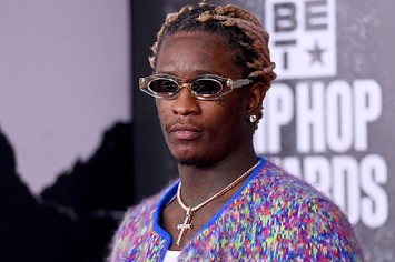Young Thug walks the red carpet in a cross necklace.