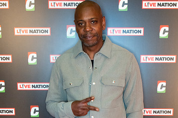 Dave Chappelle poses on the red carpet.