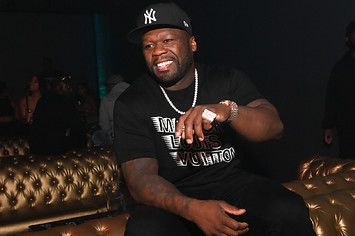Musical artist 50 Cent enjoys himself on a comfortable couch.