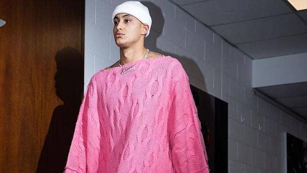 Before the Washington Wizards faced off against the Charlotte Hornets Monday, Kuzma entered the arena rocking a pink oversized Raf Simons sweater.