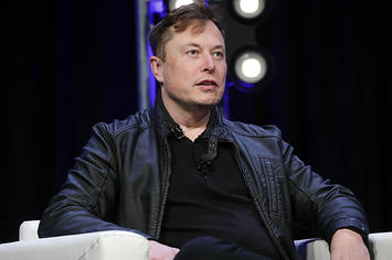 Tesla CEO and founder Elon Musk speaking onstage at a conference