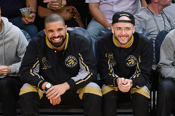 Drake and Noah "40" Shebib smiling at a Toronto Raptors game