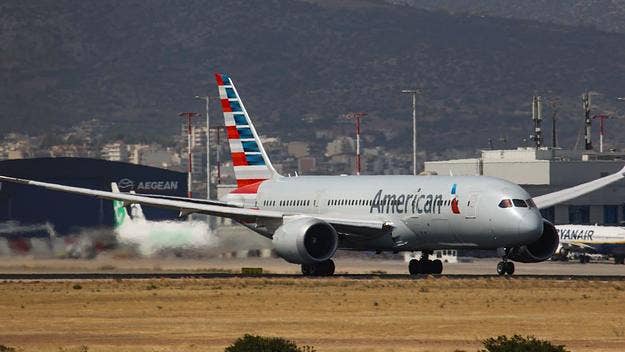 A man was arrested on Wednesday after he opened the emergency exit on an American Airlines plane and sat on the wing once the flight had landed in Miami.