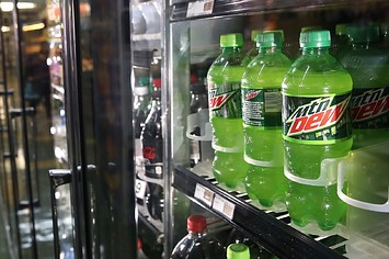 Bottles of Mountain Dew are displayed in a cooler