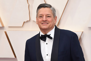 Ted Sarandos poses for photo on Oscars red carpet.