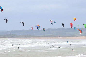 Kitesurfers enjoy with windy conditions in Camber, East Sussex