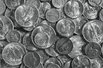 Pile of various old silver coins, close-up.