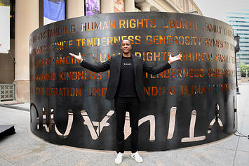 Masai Ujiri poses in front of his new 'Humanity' art installation in front of Toronto's Union Station.