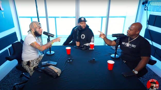 In his appearance on the first episode of DJ Akademiks' new podcast, 6ix9ine attempted to paint Snoop Dogg as a “snitch.” Wack 100 expressed his disagreement. 