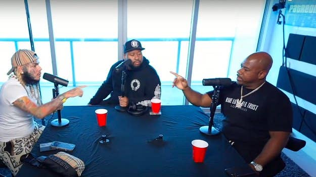 In his appearance on the first episode of DJ Akademiks' new podcast, 6ix9ine attempted to paint Snoop Dogg as a “snitch.” Wack 100 expressed his disagreement.