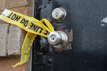 A piece of police caution tape is seen on the front door of the building where a shooting took place in Chicago.