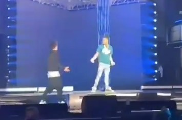 Video captured of fan getting tackled by security after jumping on stage during Lil Baby performance.