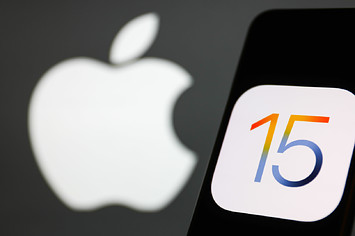 iOS 15 logo displayed on a phone screen and Apple logo in the background.