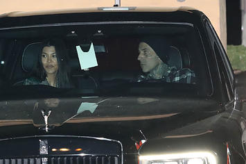 Kourtney Kardashian and Travis Barker being hounded by the paparazzi.