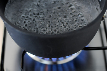 In this photo illustration water comes to the boil on a gas stove.