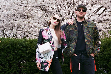 The founders of Sidewalk Hustle standing under a cherry blossom trees