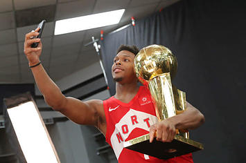 Kyle Lowry takes a selfie with the Larry O'Brien Trophy.