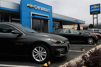 A Chevrolet Malibu is displayed at a Chevrolet dealership