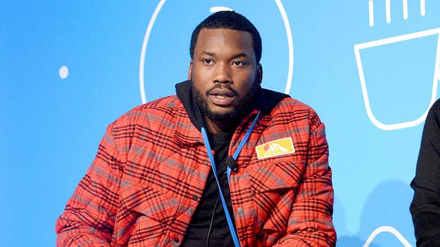 A sources-filled report says rappers Meek Mill and Travis Scott got into a verbal disagreement while at Michael Rubin's Fourth of July party.